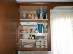 This is our dish cabinet nice and neat with the white cabinet organizers.