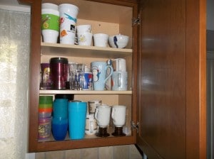 Cups and glasses in our cabinets very disorganized before we organized them.