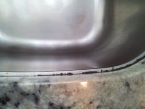 After a year or two the old dark grey caulk line starts to pull away from the sink.