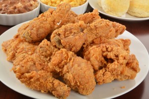 A plate of fried chicken with side dishes