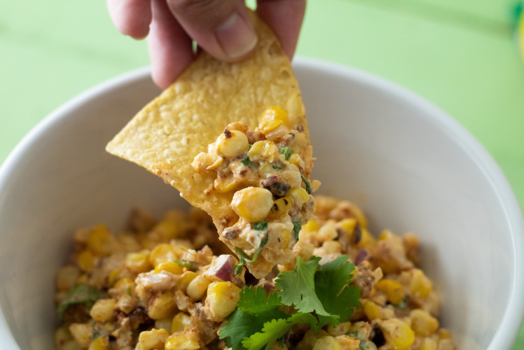 Chip in hand going for the a bite of this grilled corn and chorizo dip
