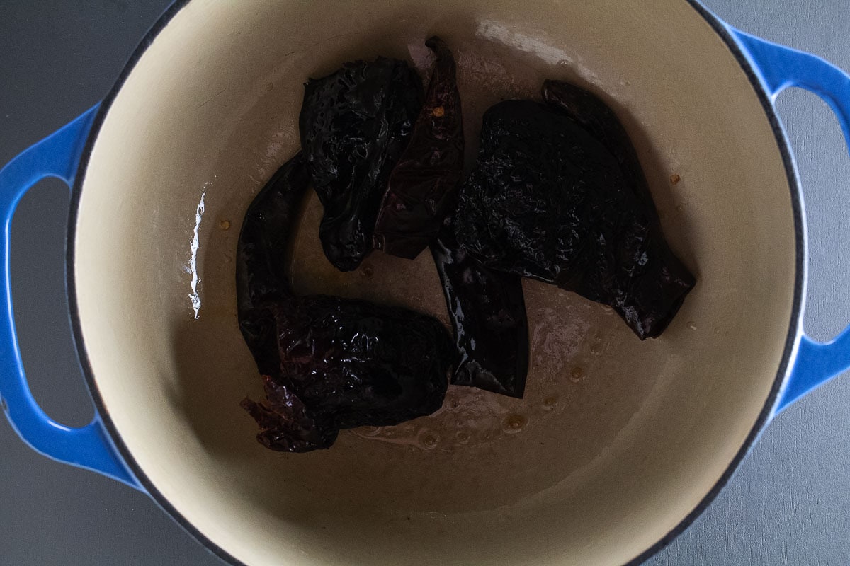 This image shows us quickly pan frying the peppers in our dutch oven.