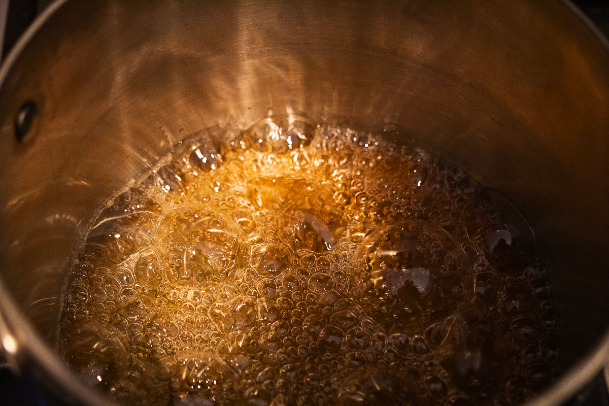 This image shows the first step in the caramel process. It is an amber color and it is bubbling.