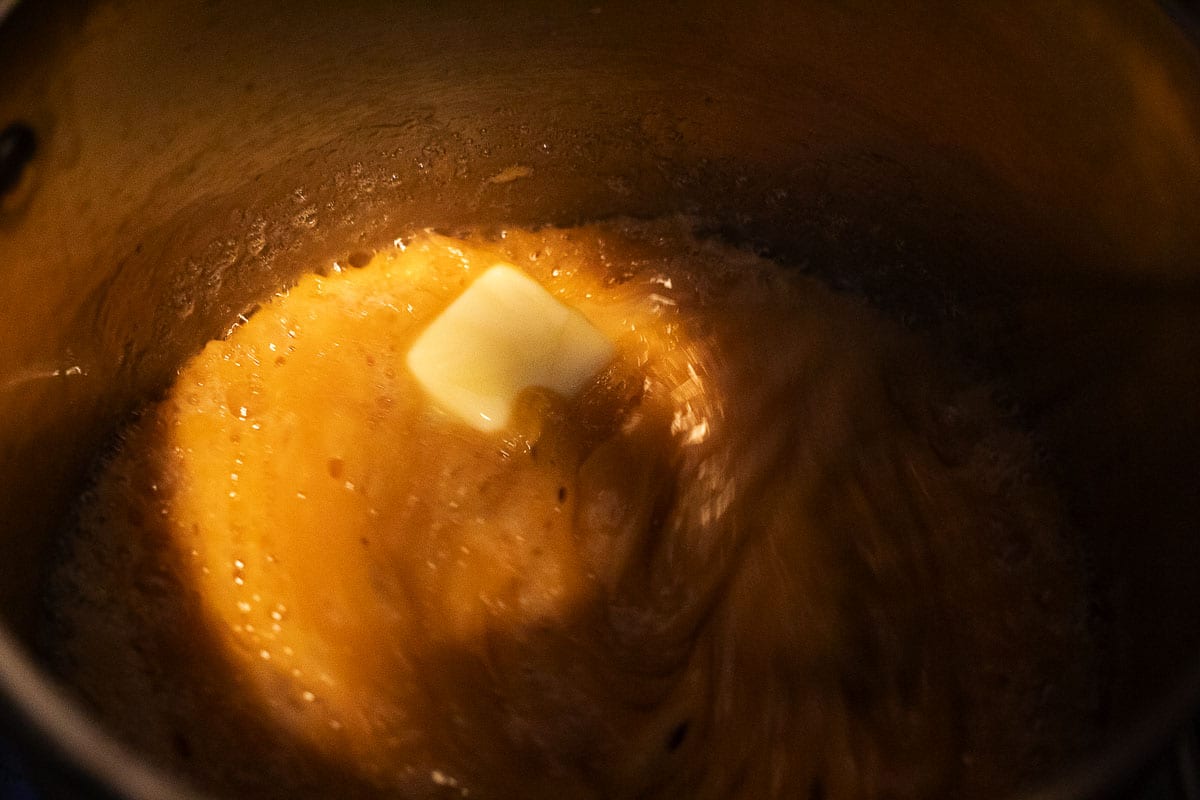 This image shows the butter being mixed into the caramel sauce.