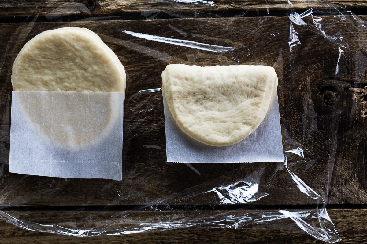 This is an image of the cut out bao bun dough with parchment paper.