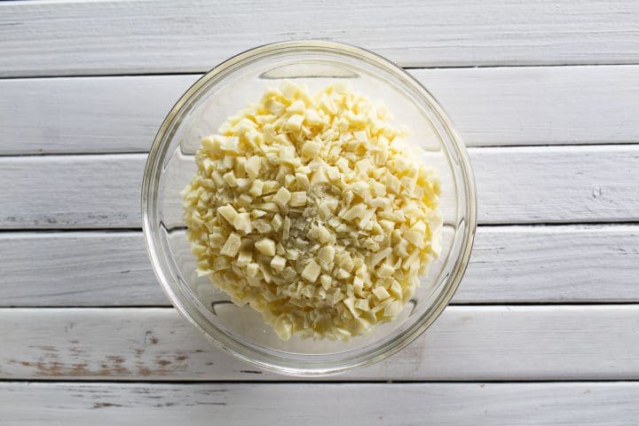 Chopped white chocolate in a bowl.