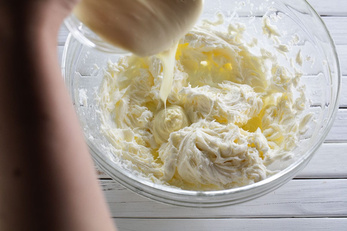 This is an image of white chocolate being added to frosting.