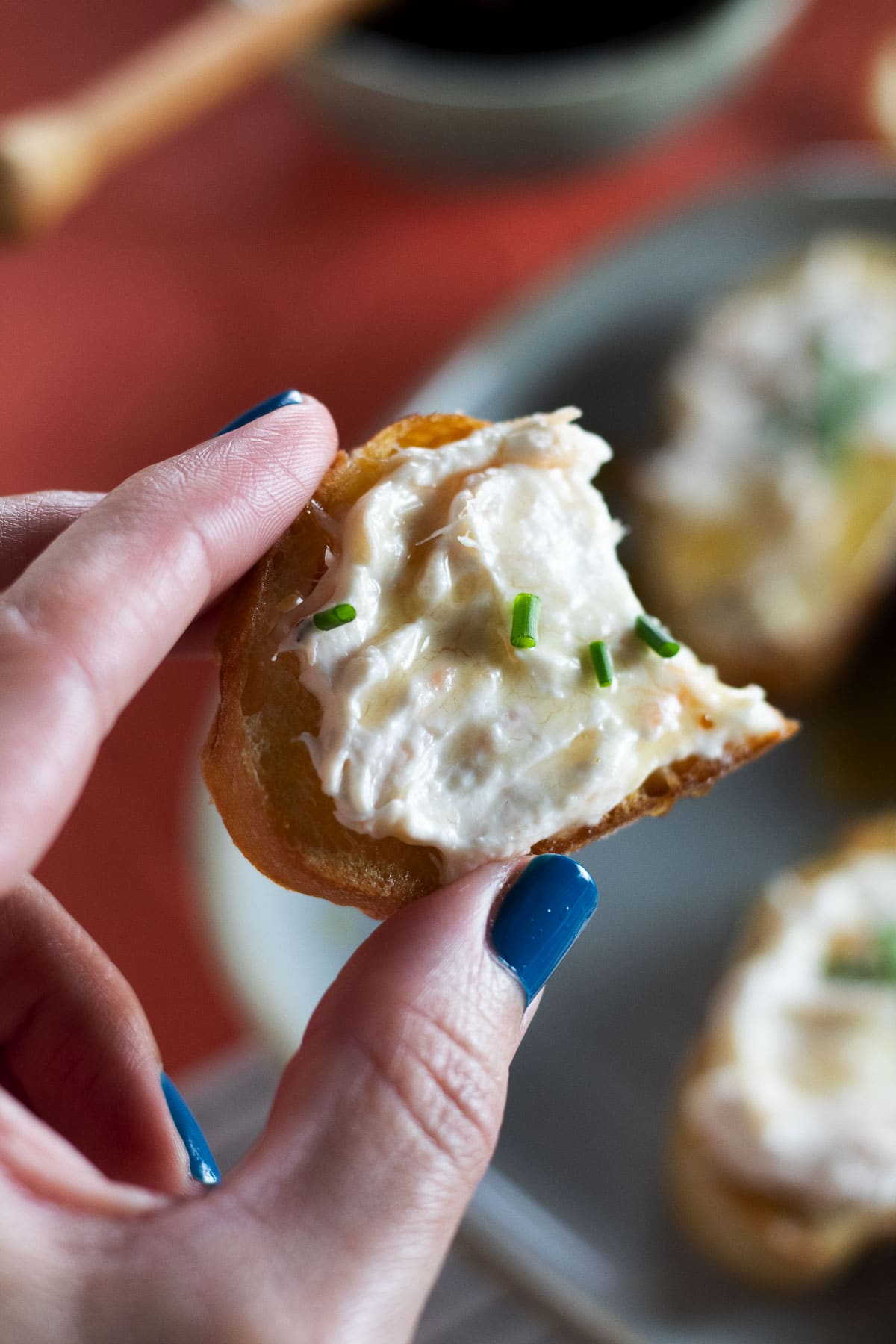 This is an up close bite shot of our hot honey smoked salmon crostini.