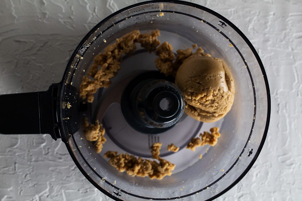 The peanuts in the food processor in the second phase will roll into a ball.