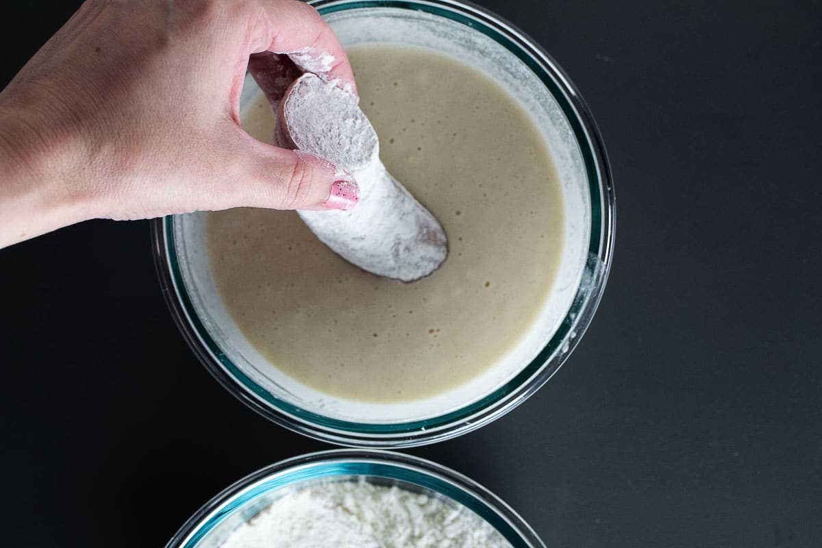 This is an image of the sausage dipped in flour then immediately into the batter.