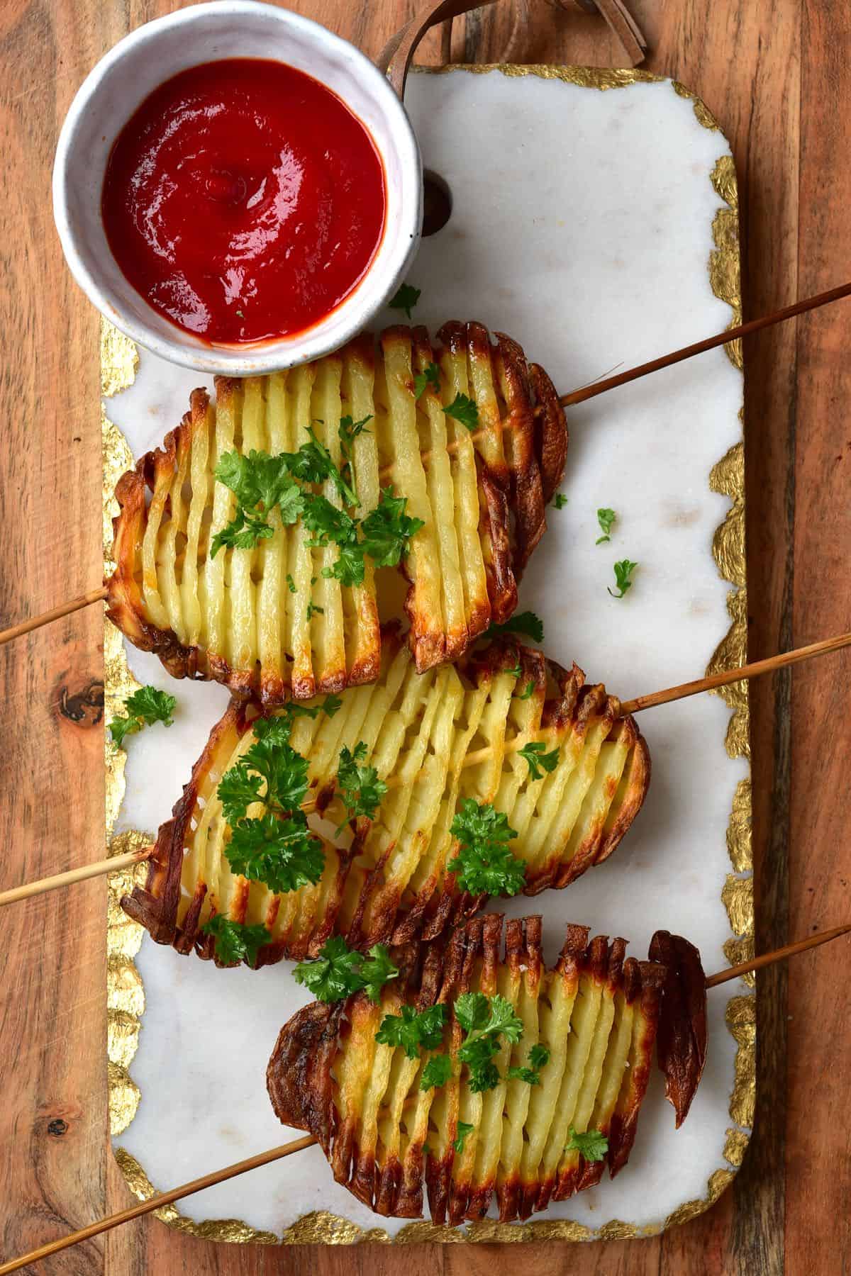 Crispy accordion potatoes on a stick from Alpha Foodie.