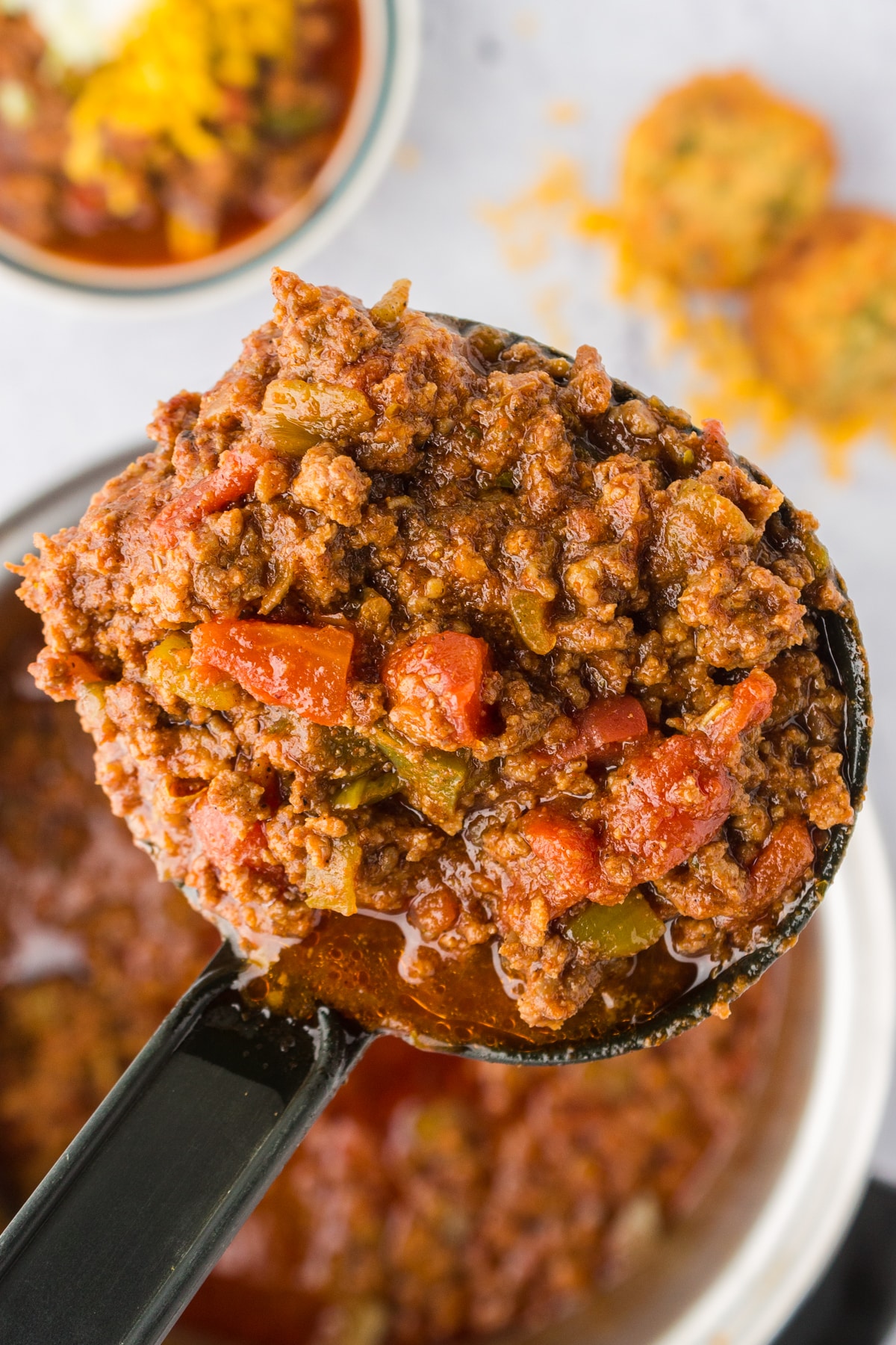 Easy beef and chorizo chili recipe in a serving spoon.