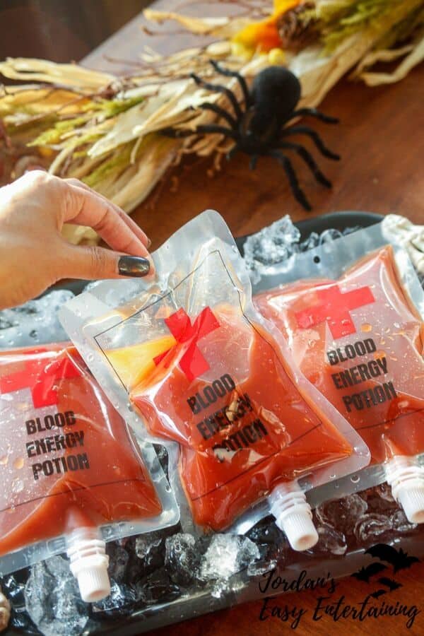 Stack of Bloody Mary alcohol drinks in fun faux IV bags on a tray.