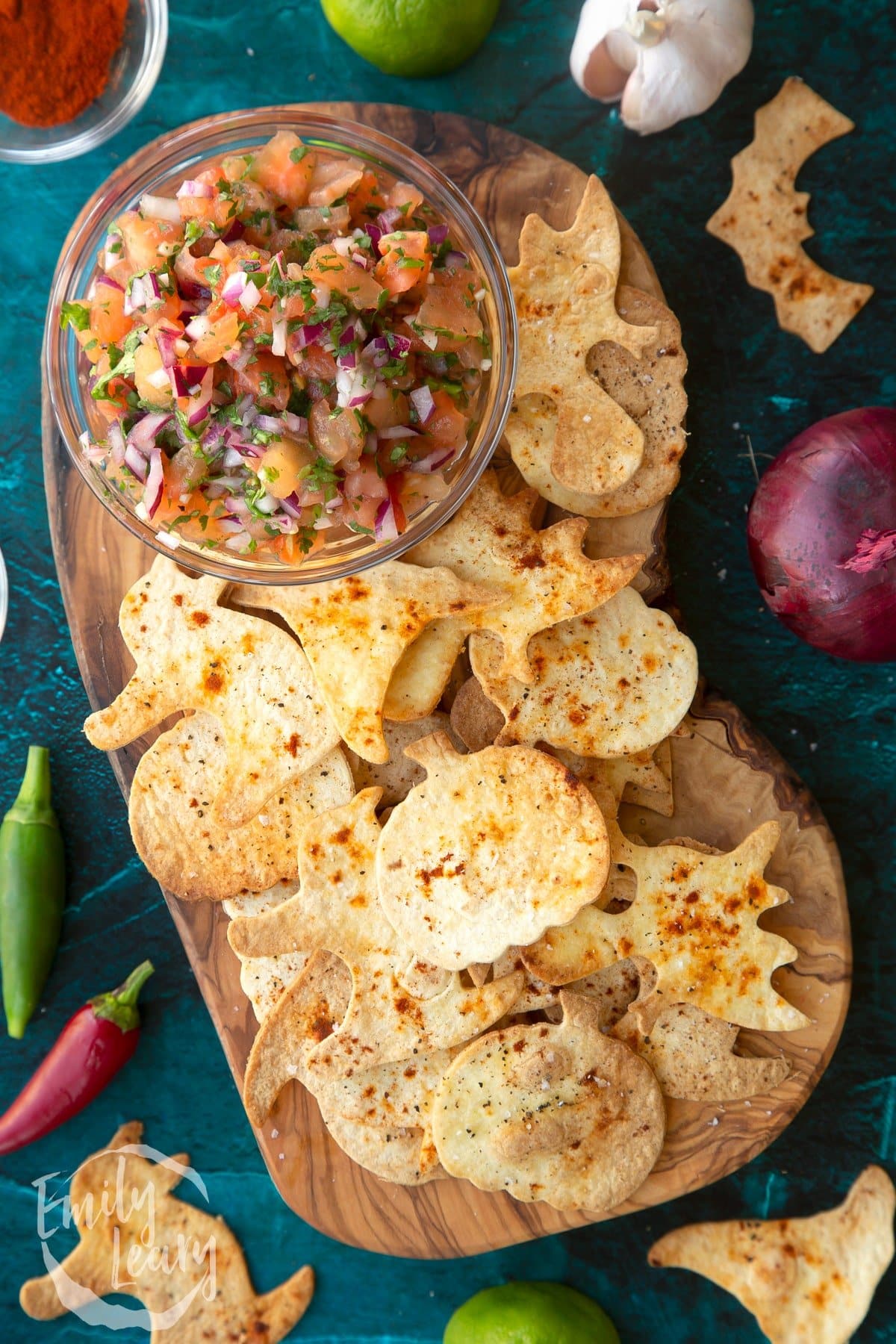 Halloween tortillas served with salsa with blue background.