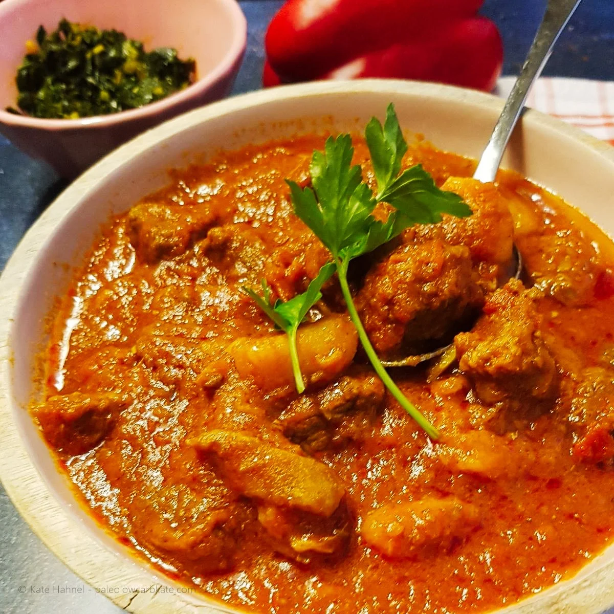 Kenyan beef stew in bowl with spoon.