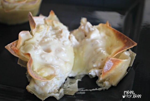 Alfredo lasagna cups on a black serving tray.