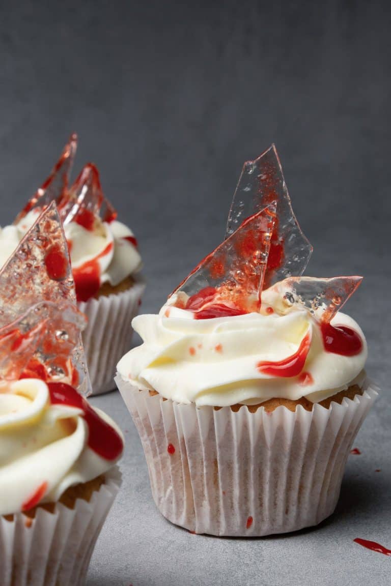Halloween cupcakes with sugar glass shards and strawberry puree blood.