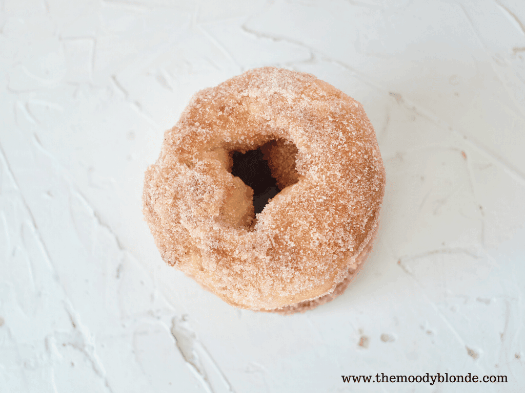 Caramel apple donut on white background.