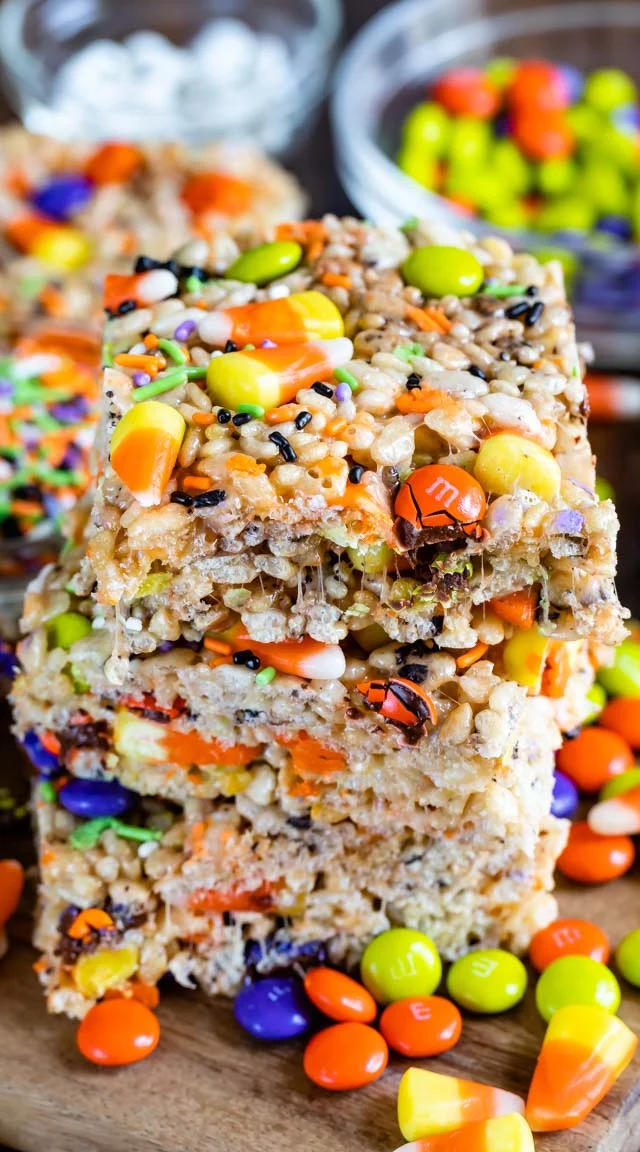 Stack of Rice Krispies treats with candy corn, m&m's, and multicolored sprinkles.