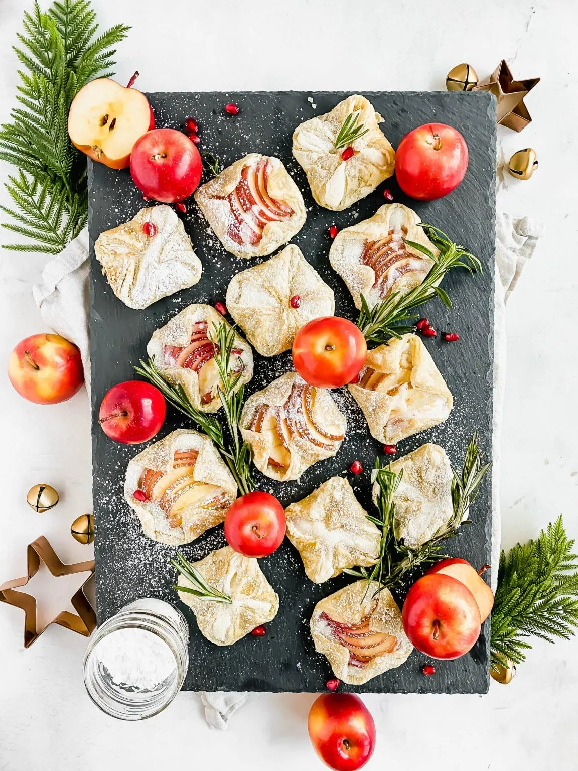 Apple cream cheese danishes on a slate board.