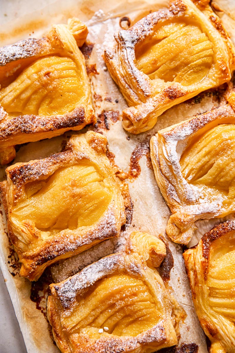 Pear tarts with powdered sugar sprinkled on them.