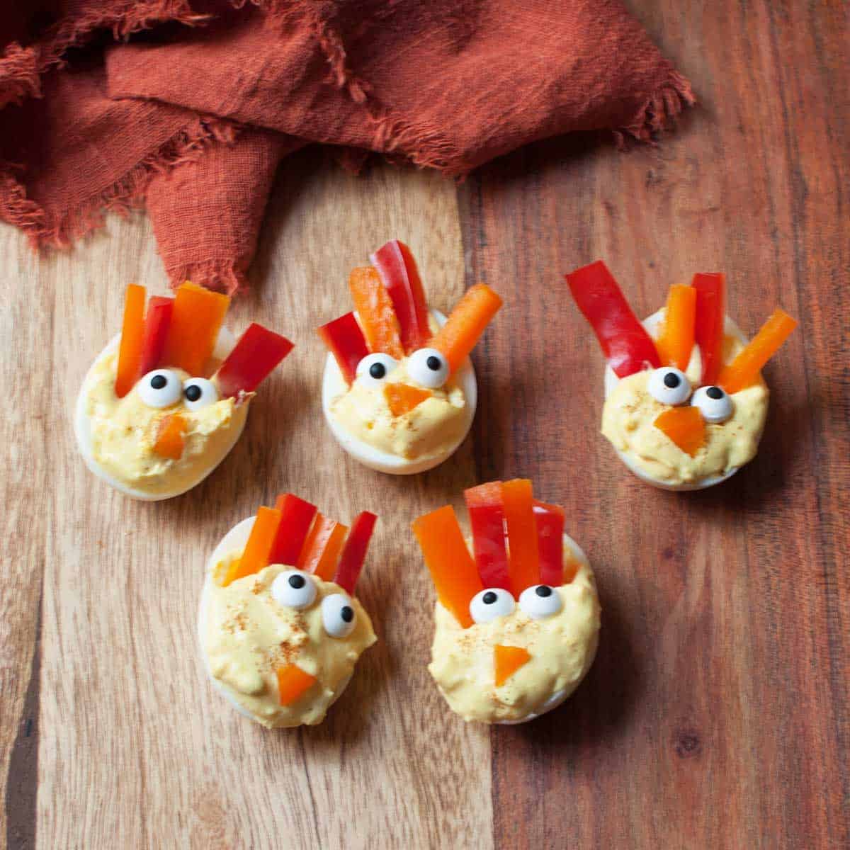 Thanksgiving deviled eggs on wooden background.