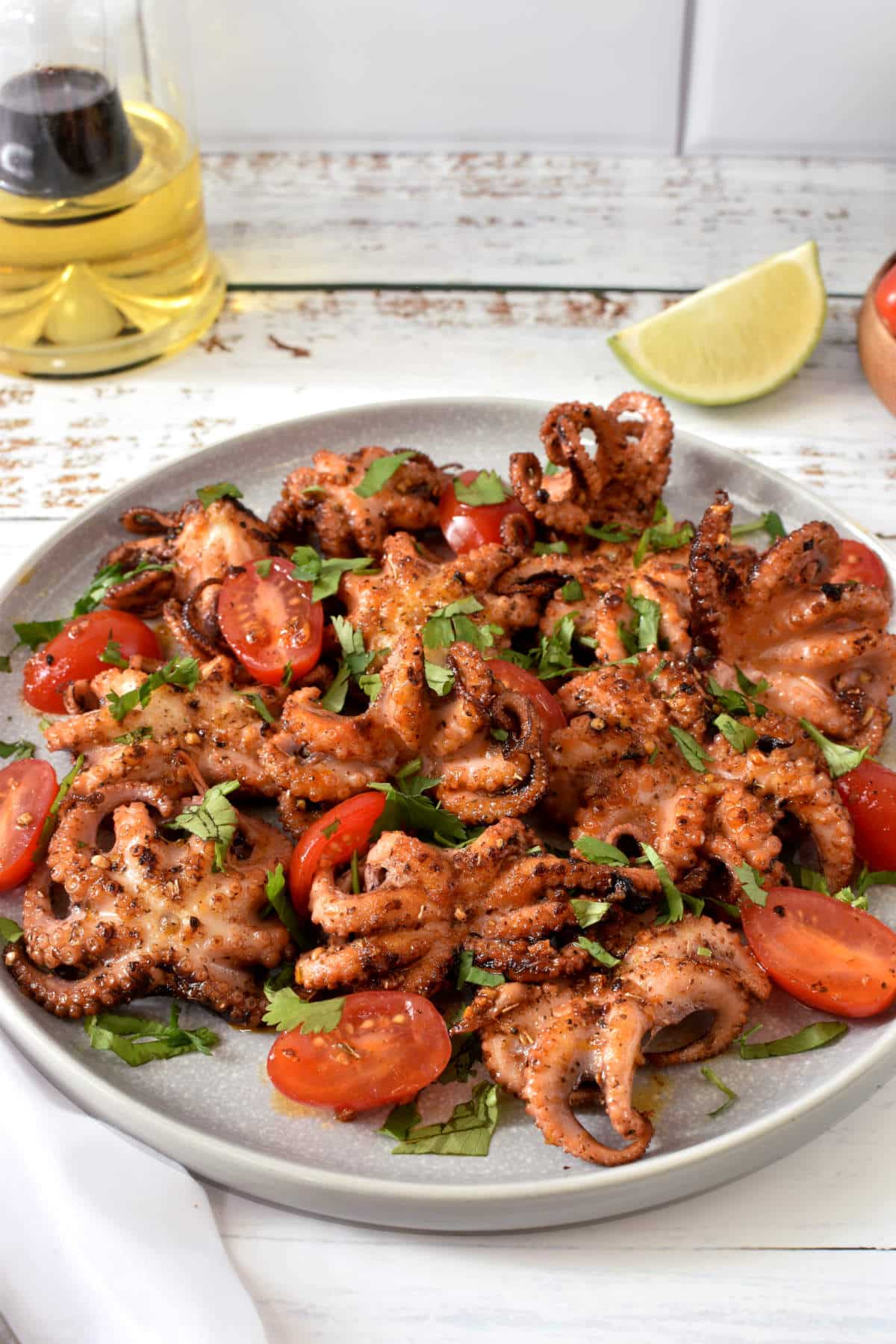 Baby octopus recipe on a plate with white background.