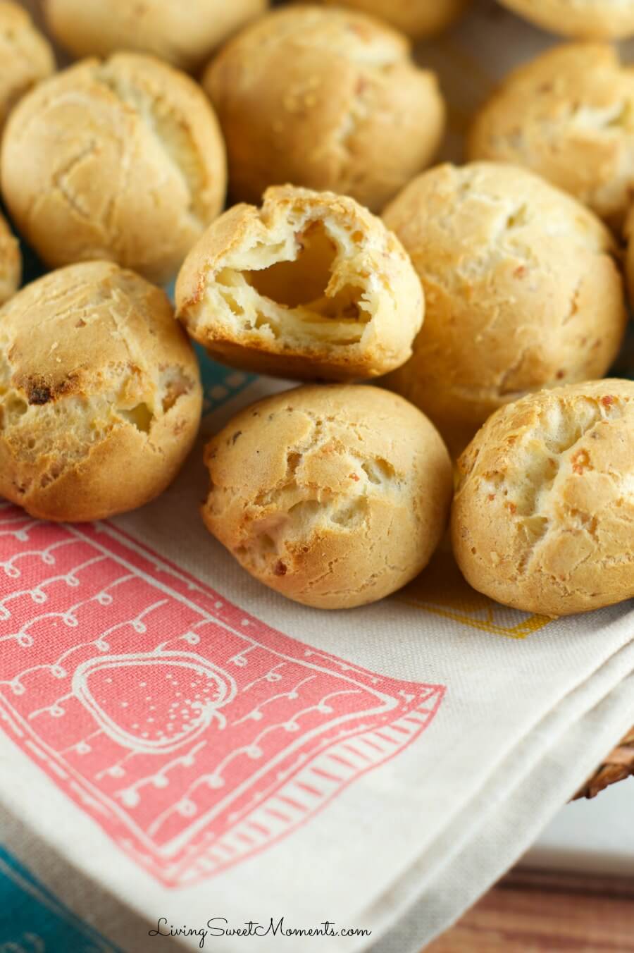 Lots of bacon and cheese gougeres in a napkin lined basket.