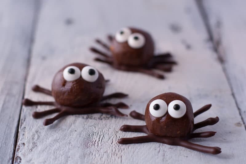 Chocolate peanut butter spiders on white background.