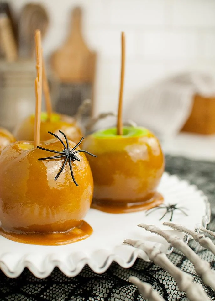 Caramel apples with plastic spiders.