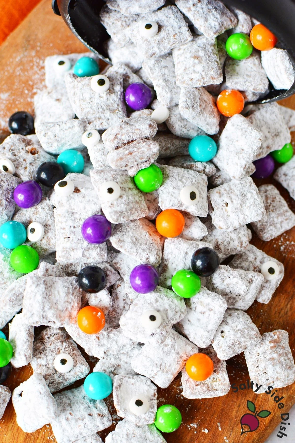 Halloween puppy chow shown with a mix colorful candies.