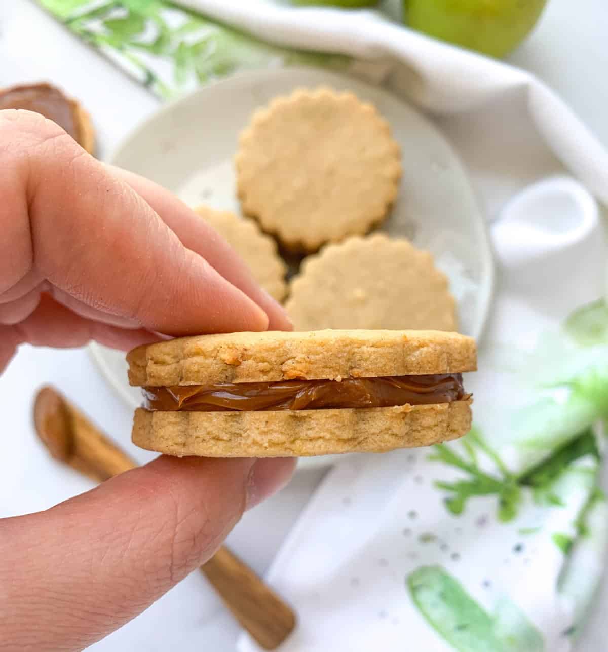 Hand holding caramel apple cookie.