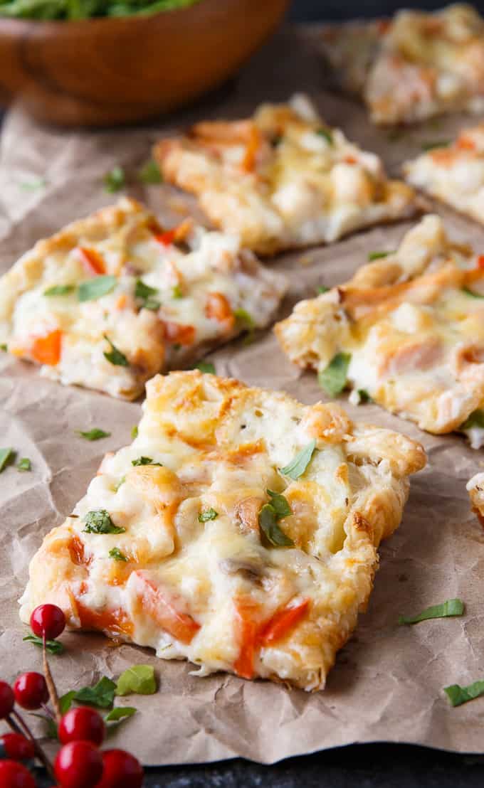 Puff pastry seafood pizza on parchment paper.