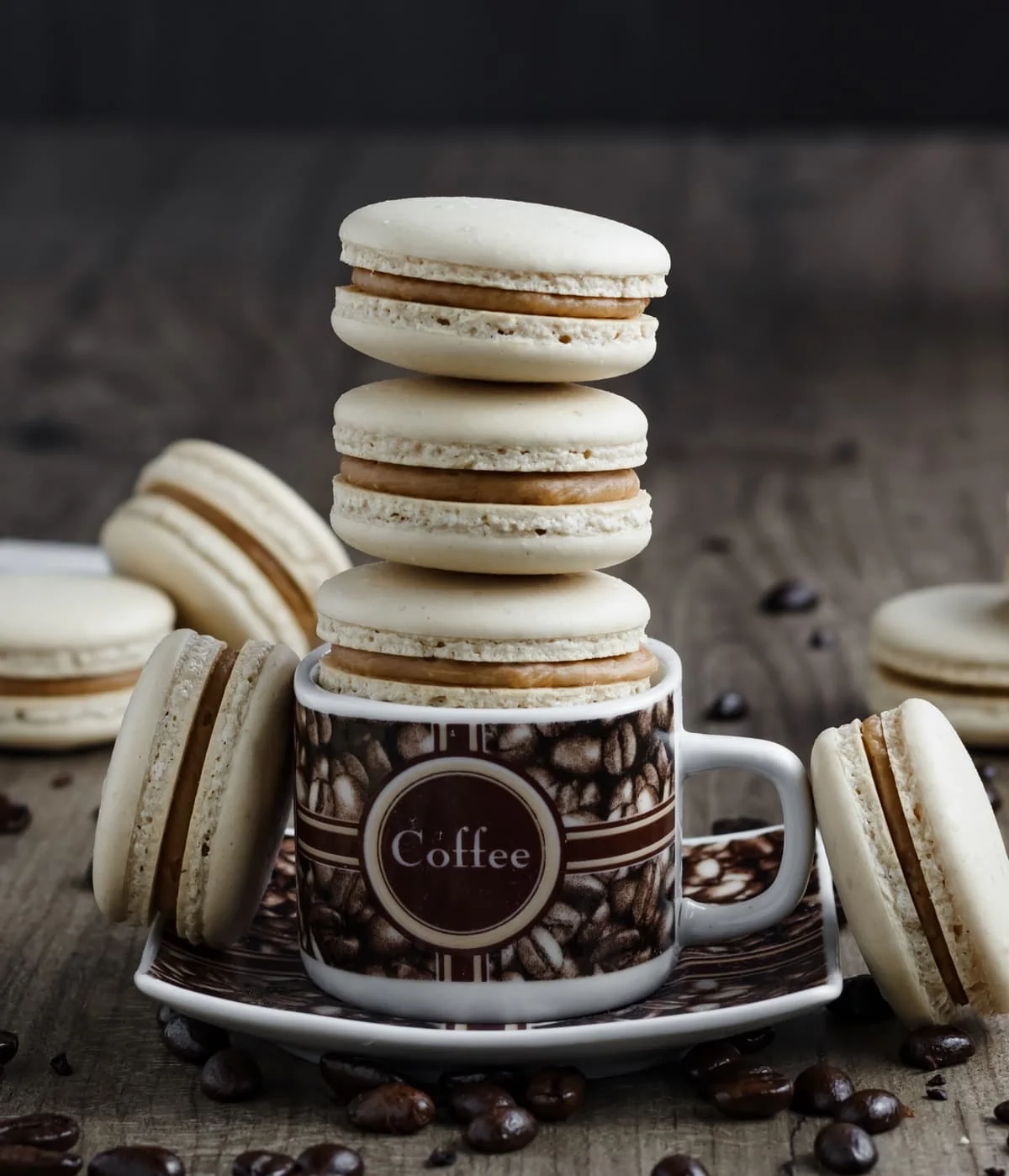 Coffee Macarons stacked inside a coffee mug.