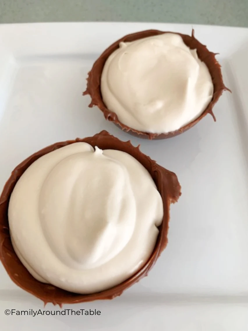 Coffee mousse in chocolate cups on white background.