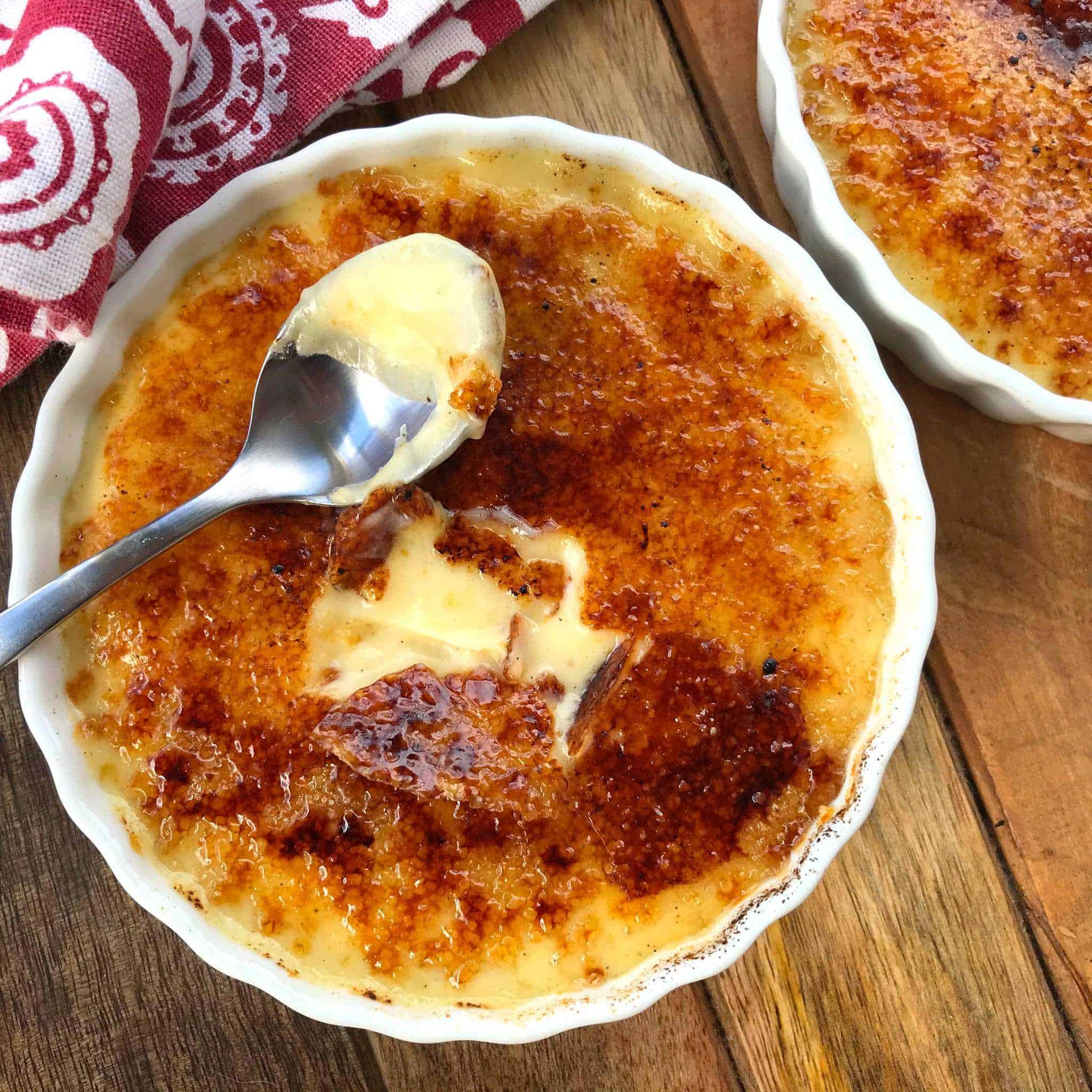 Crema catalana in a ramekin with spoon.