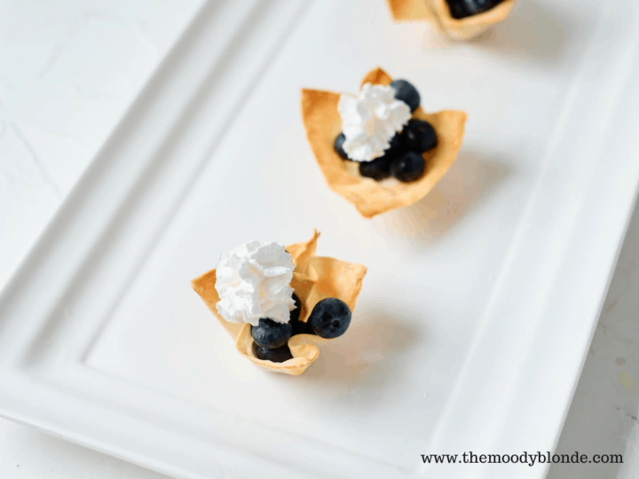 Wonton cups with fresh blueberries and whipped cream.