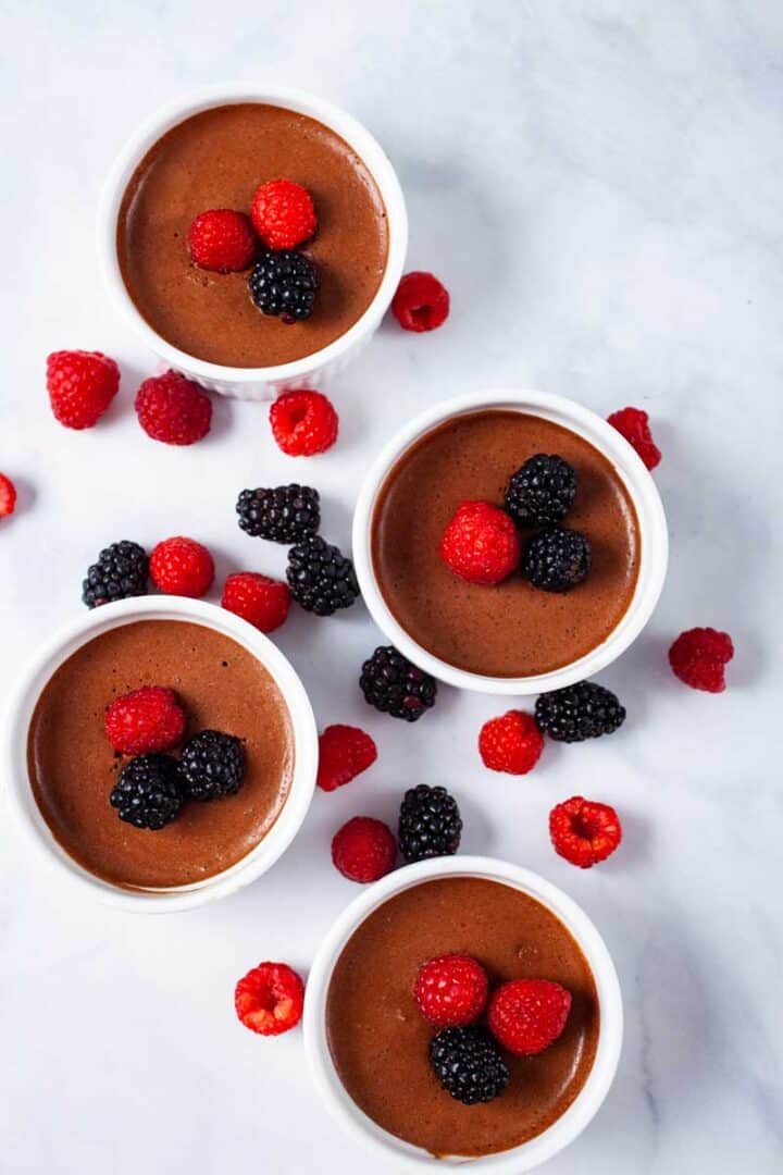 Chocolate coffee mousse in ramekins with berries.