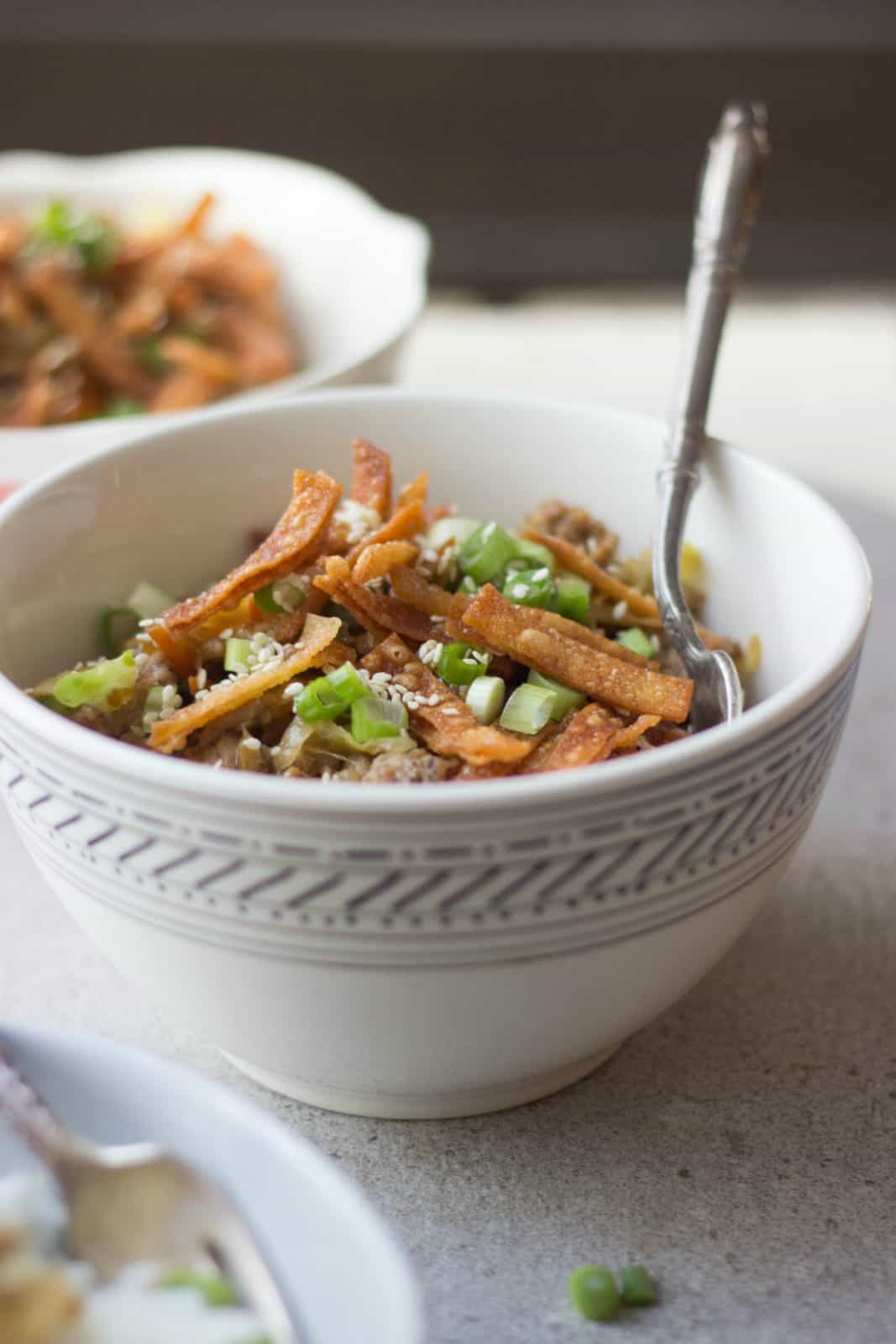 Deconstructed egg roll in a white bowl.