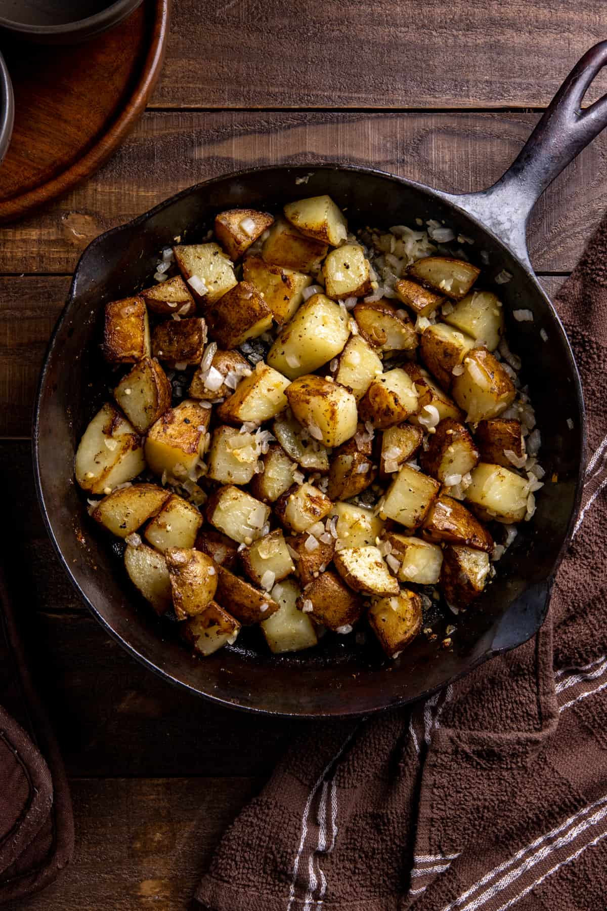 Fried potatoes and onions in a cast iron pan.