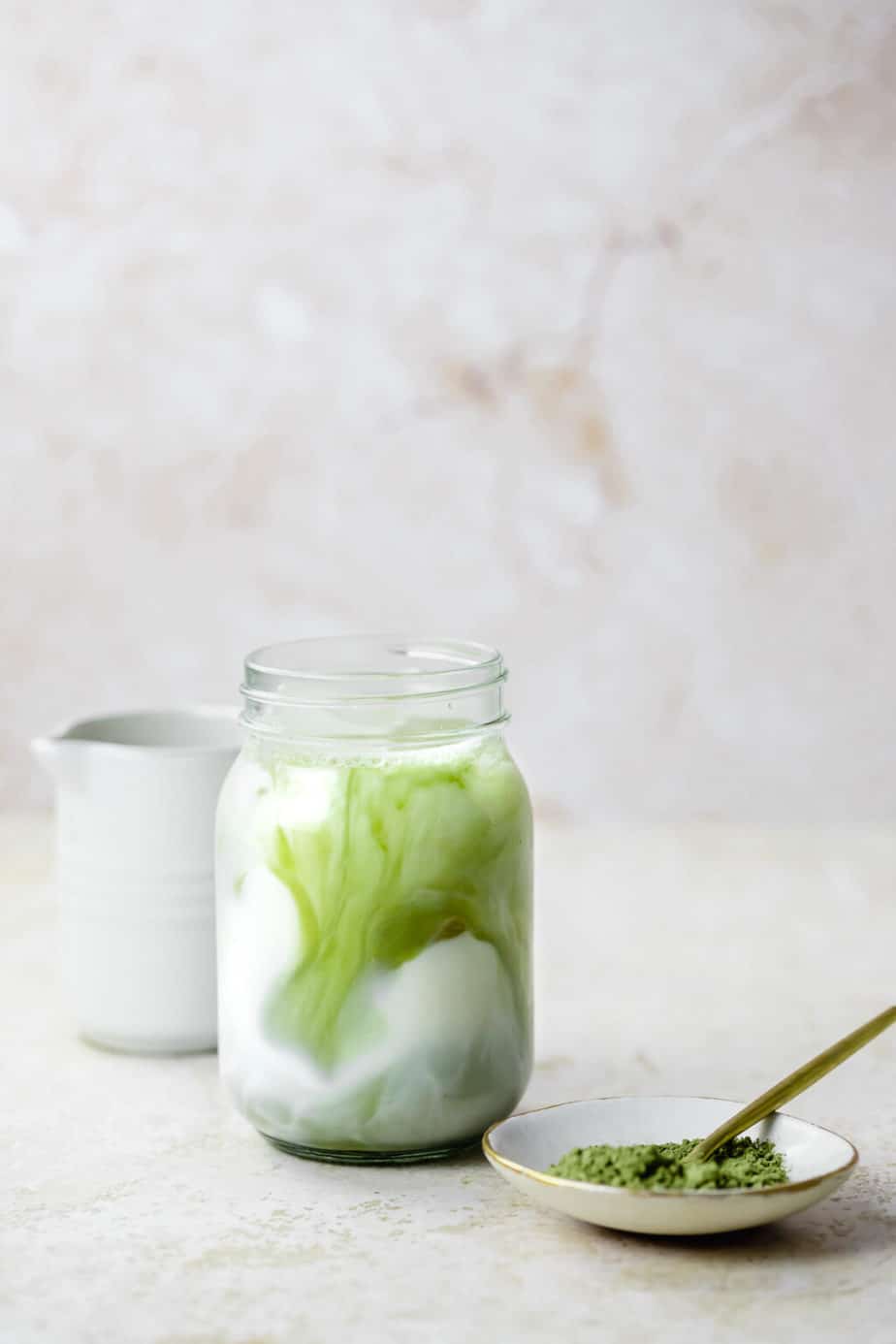 Iced vanilla matcha latte in a mason jar.