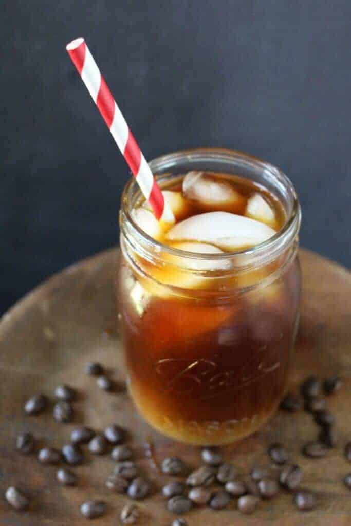 Iced cold brew coffee in a jar with straw.