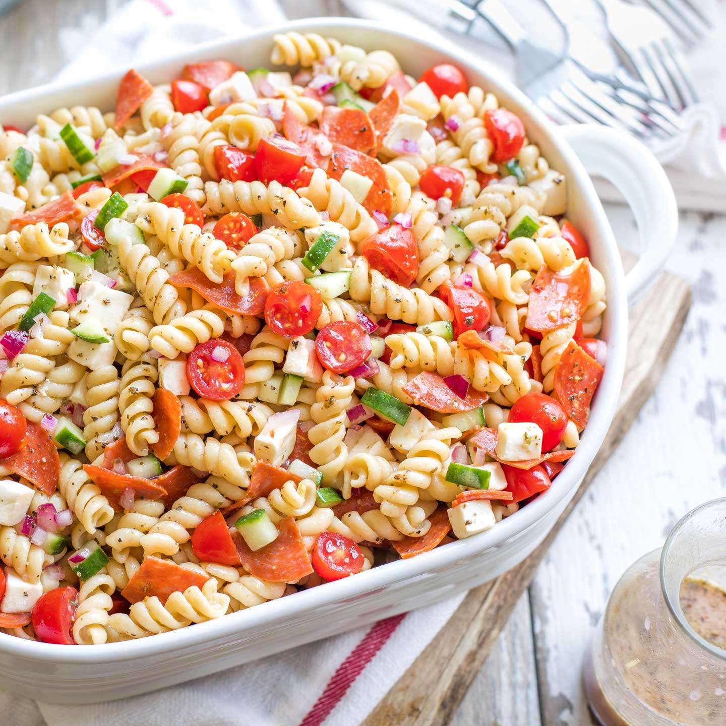 Italian pasta salad with turkey pepperoni and homemade dressing in a casserole dish.