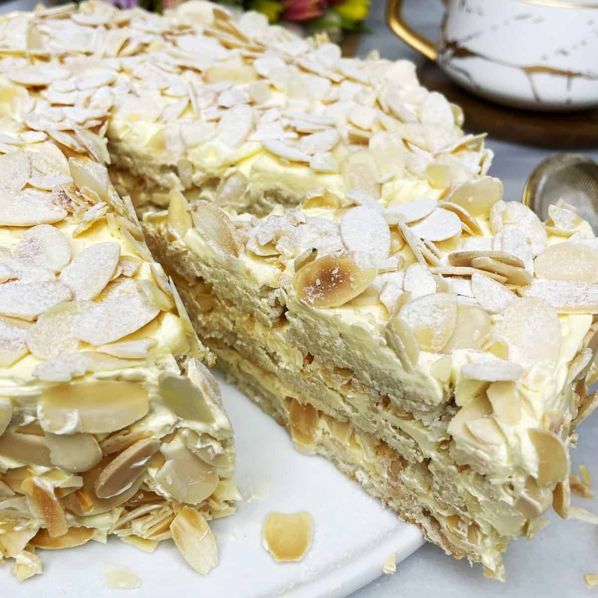 Italian almond cake with slice pulled out on a cake stand.