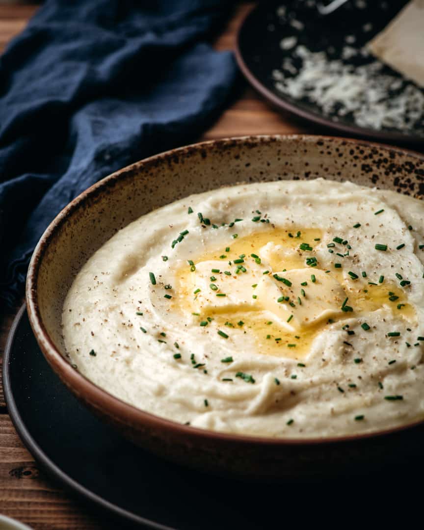 Large bowl of parmesan peppercorn mashed potatoes.