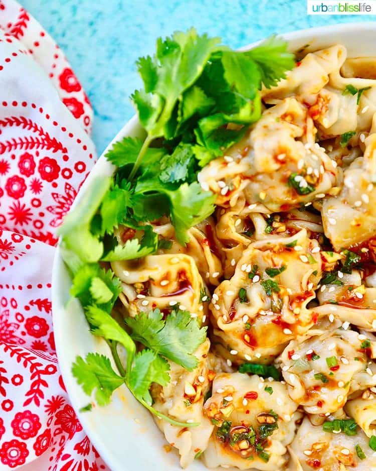 Shrimp And Pork Wontons with chili oil on white plate.