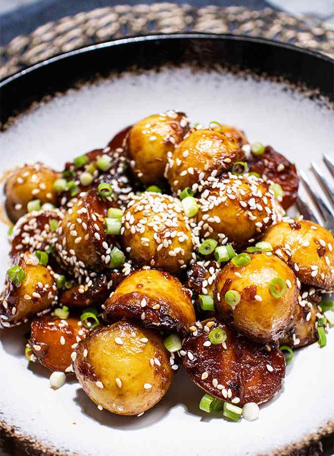 Crispy, maple glazed, pan fried potatoes with scallions and sesame seeds.