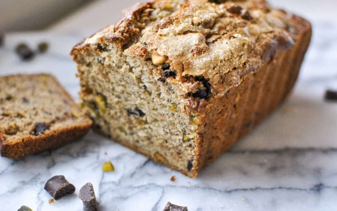 Banana bread with tahini on a marble countertop.