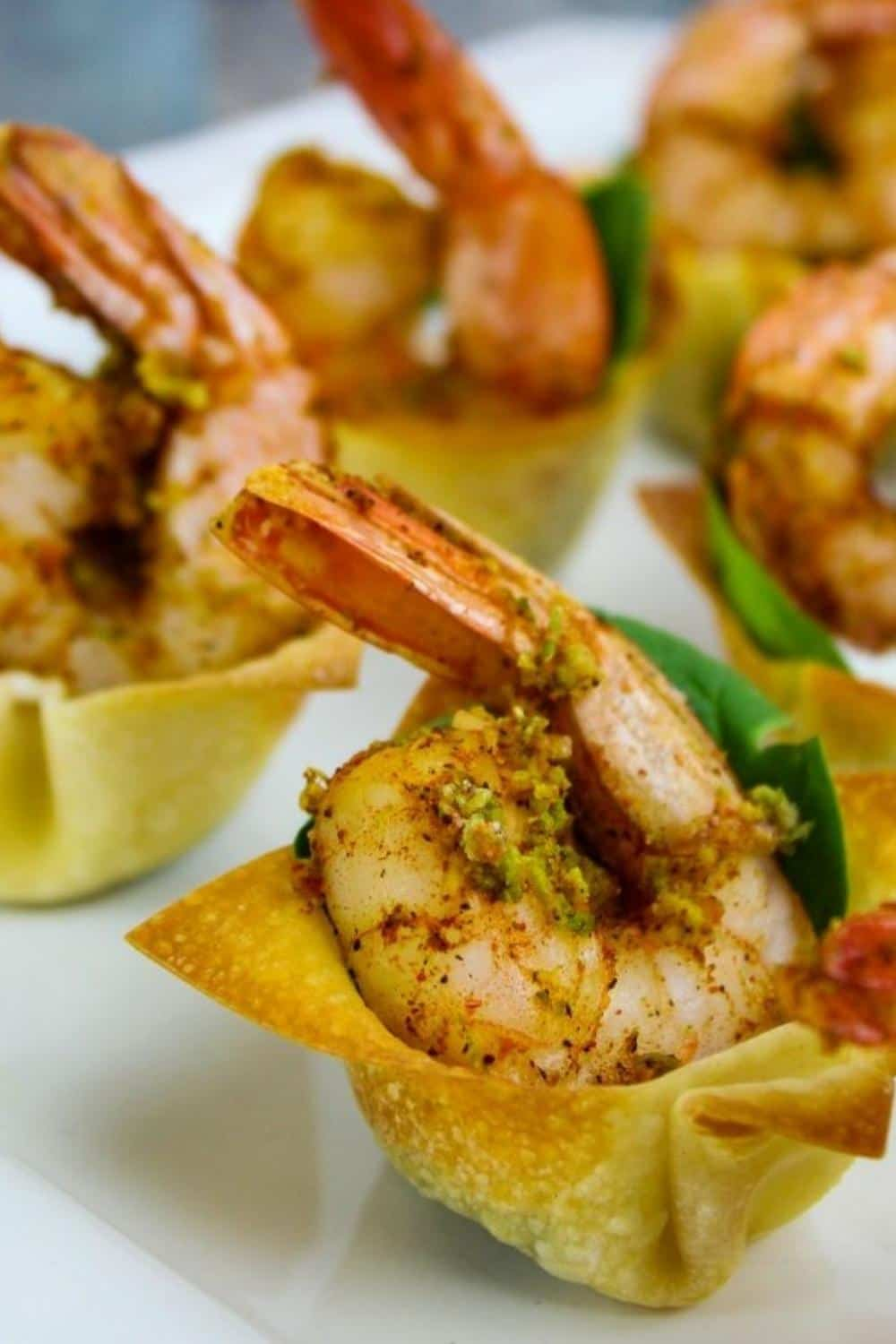 Cajun shrimp wonton cups on a white plate.