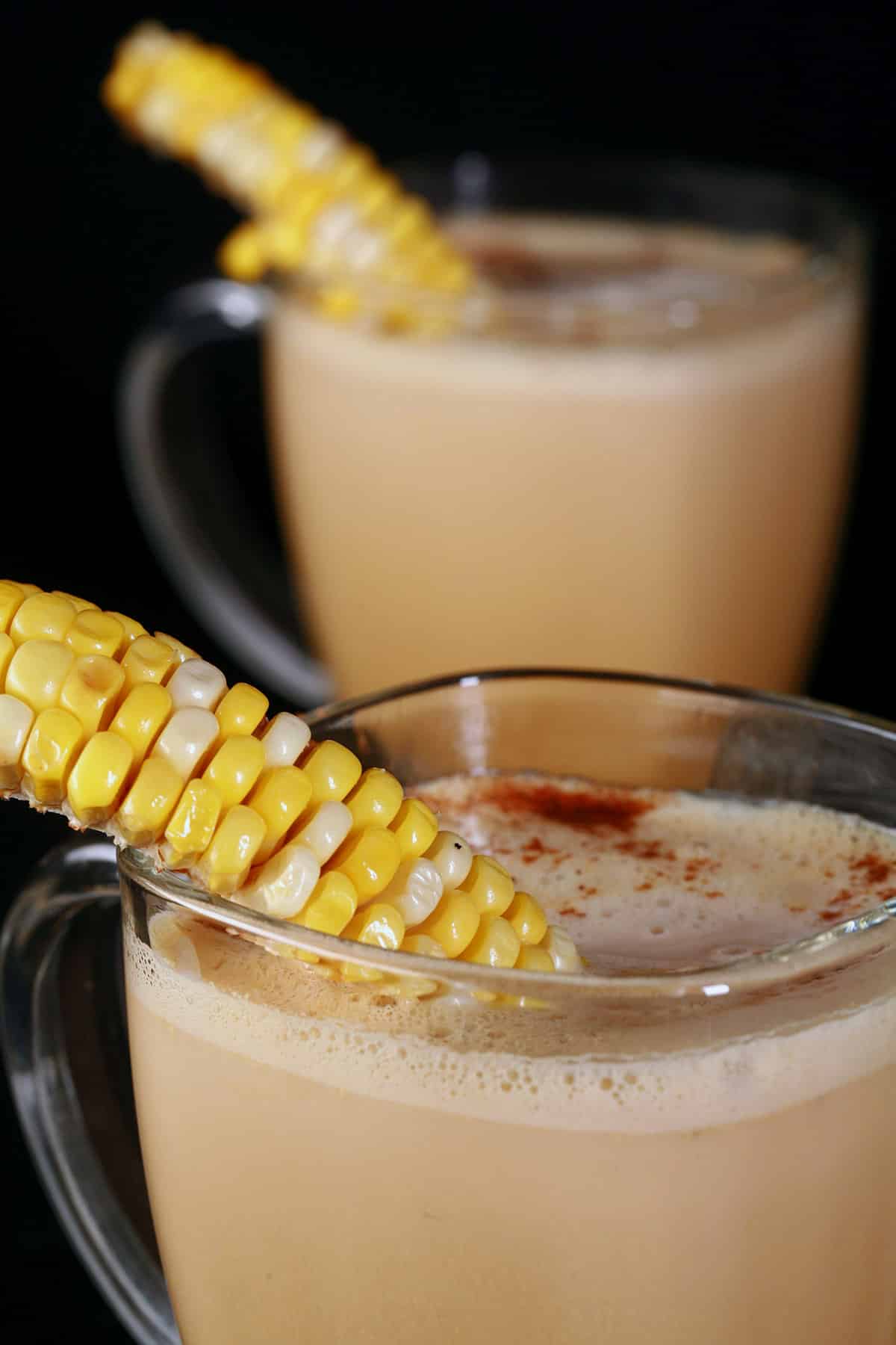 Corn cappuccino servings in clear mugs.
